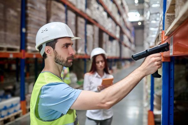 man-scanning-barcode-from-cargo-woman-with-tablet